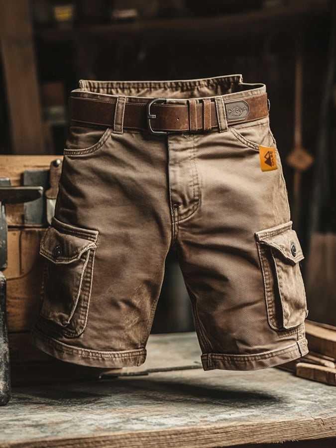 Beige cargo shorts styled with brown leather belt, rugged workshop setting