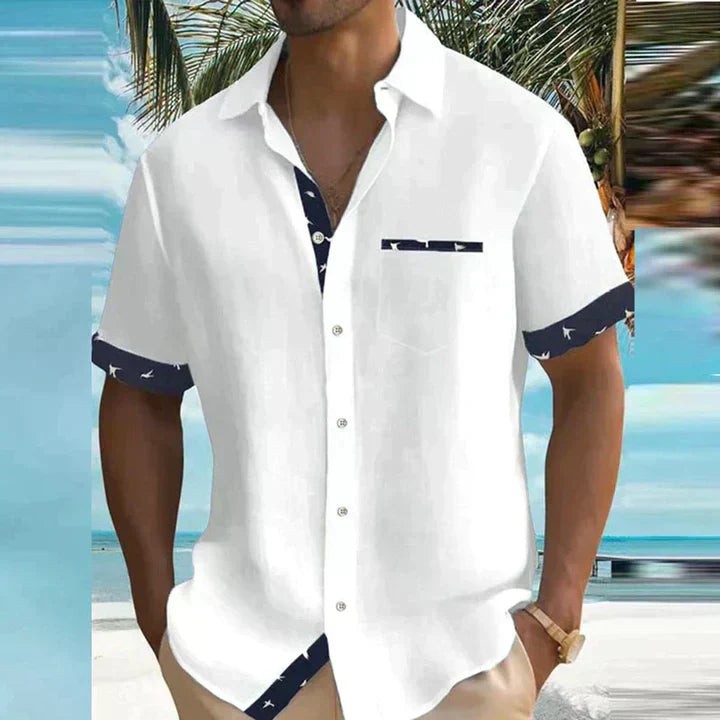 White short-sleeve shirt with navy bird-print contrast trim and chest pocket