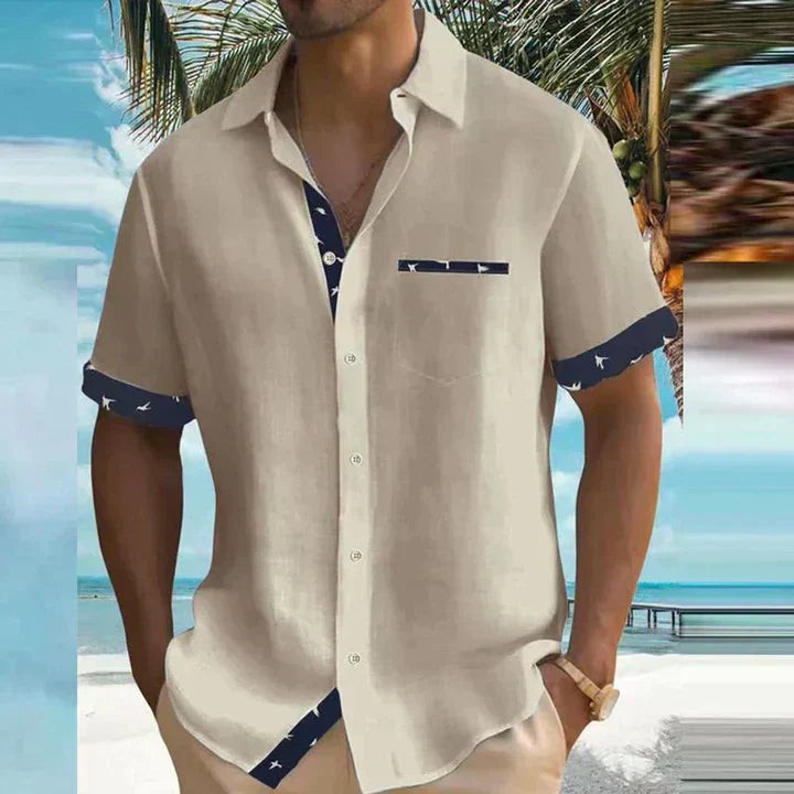 Beige short-sleeve shirt with navy bird-print contrast trim and button front