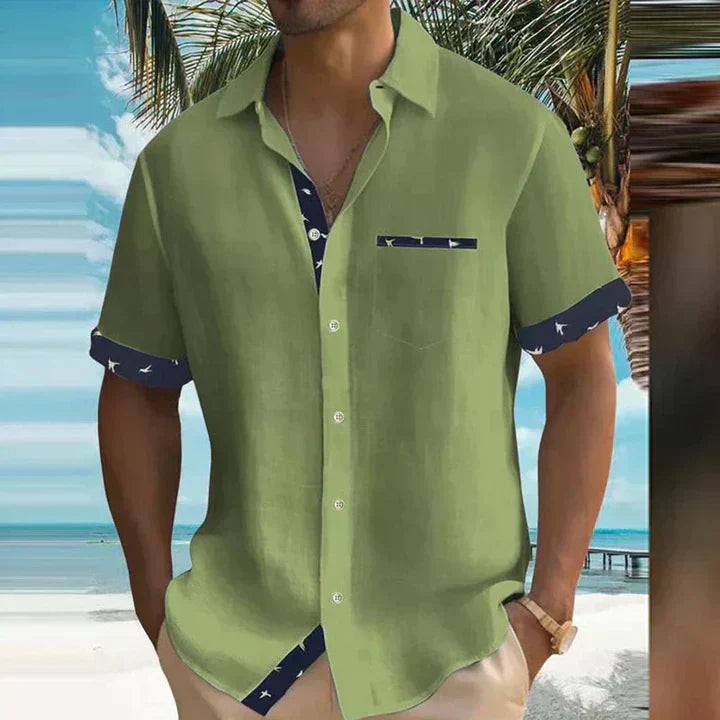 Sage green short-sleeve shirt with navy bird-print contrast trim, beach style