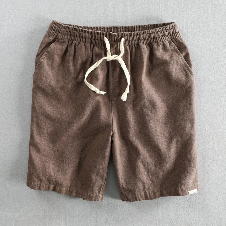 Dark brown linen shorts featuring elastic waistband and cream drawstring