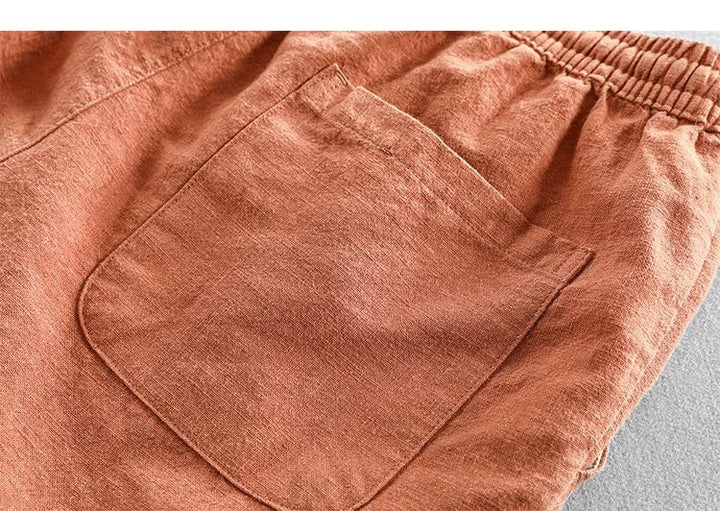 Close-up of terracotta linen shorts highlighting patch pocket detail