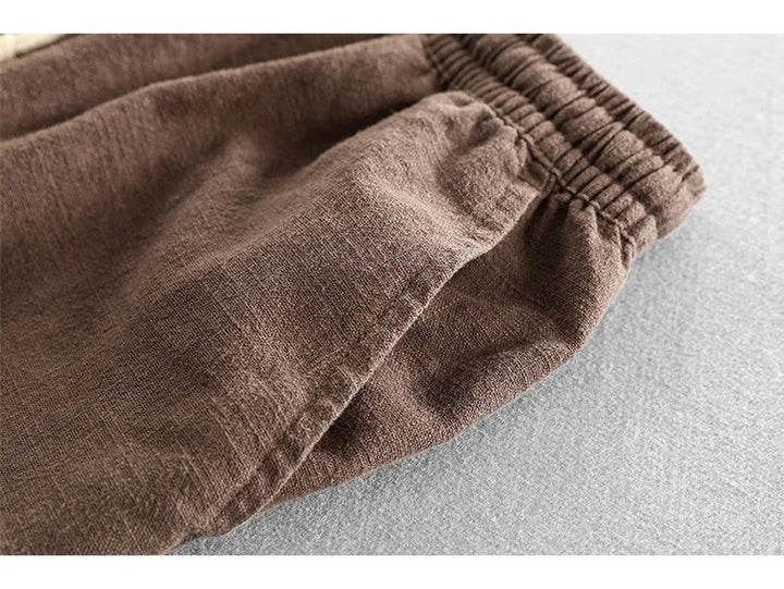 Close-up of brown linen shorts showing elasticated waistband stitching