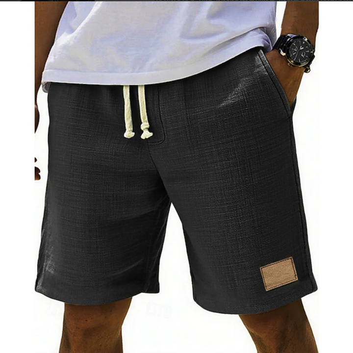 Charcoal black linen-style shorts with cream drawstring waistband