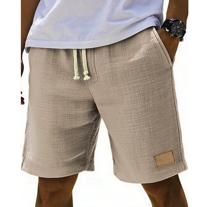 Beige linen-textured shorts with cream drawstring and leather patch