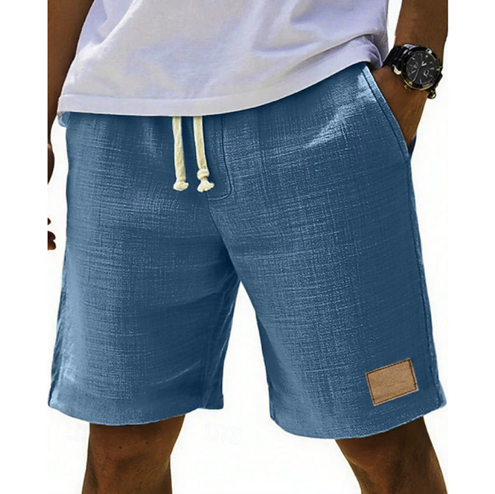 Denim blue linen-style shorts with drawstring waist and leather patch