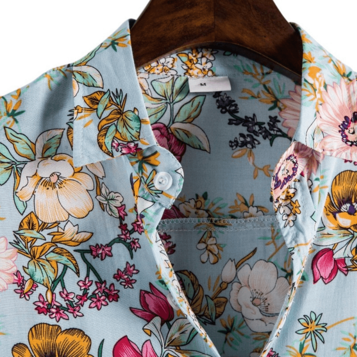 Close-up of collar and buttoned placket on pale blue floral short-sleeve shirt