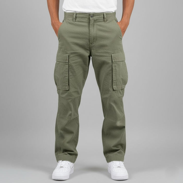 Olive green cargo trousers worn with white trainers, front view