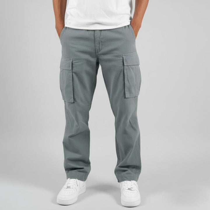 Grey cargo trousers paired with white trainers, front-facing view