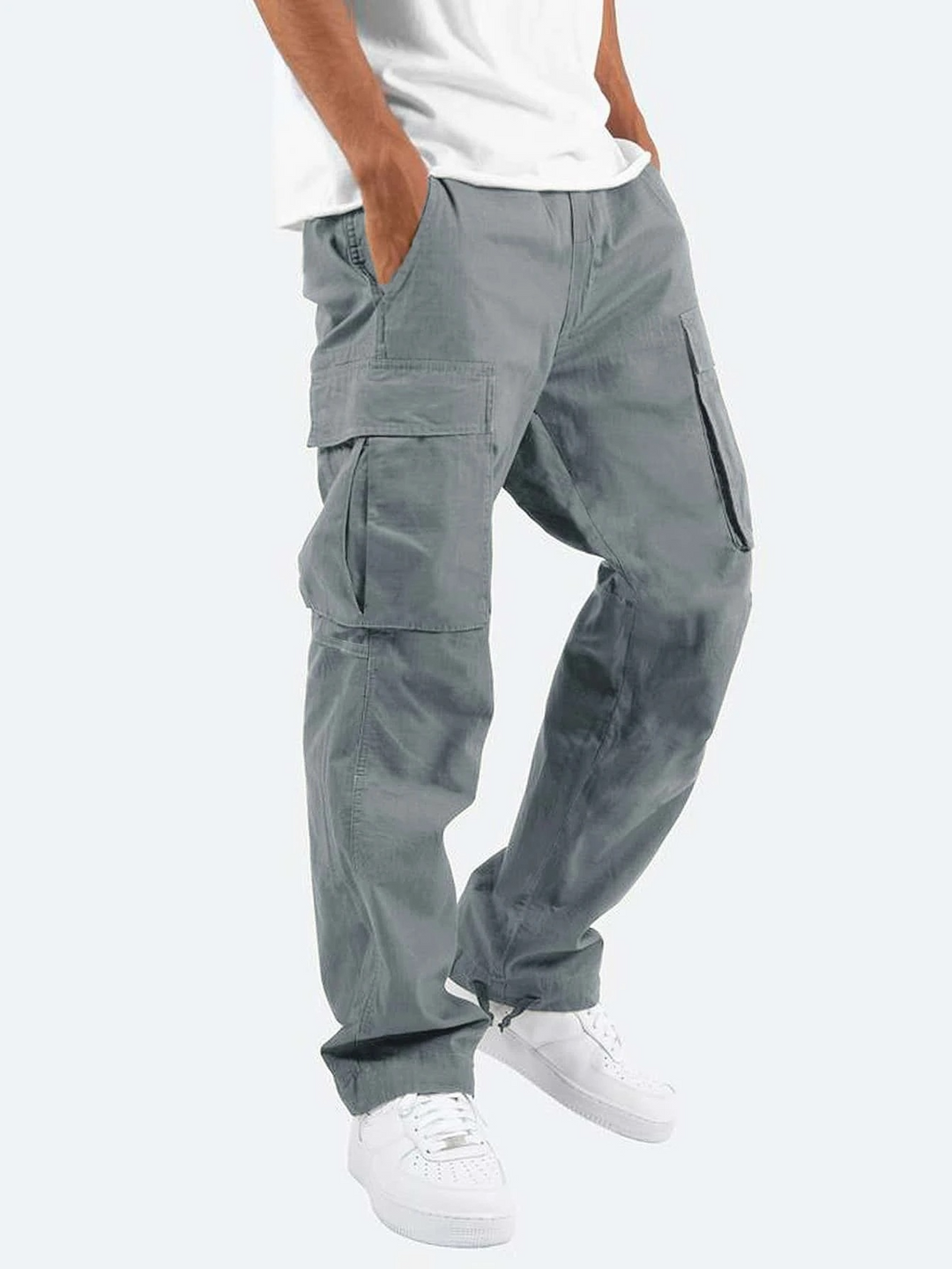 Grey cargo trousers featuring a relaxed fit and side utility pockets, styled with trainers