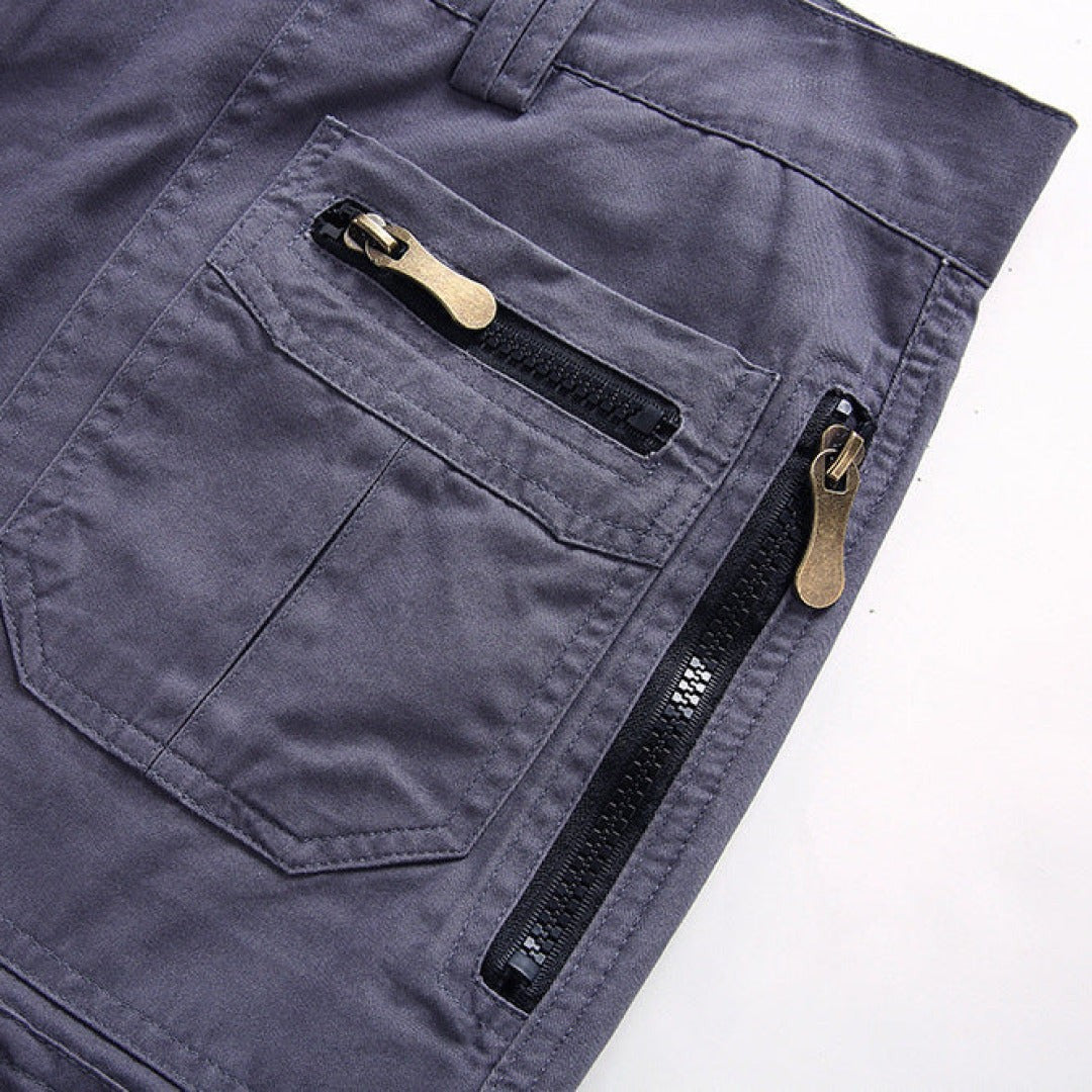 Grey cargo shorts rear pocket detail with twin bronze zip fastenings