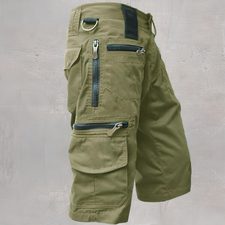 Olive green cargo shorts showing multiple zip pockets and flap detailing