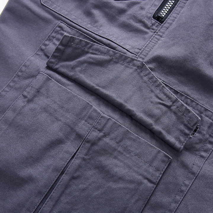 Close-up of grey cargo shorts' diagonal zip pockets and stitched seams