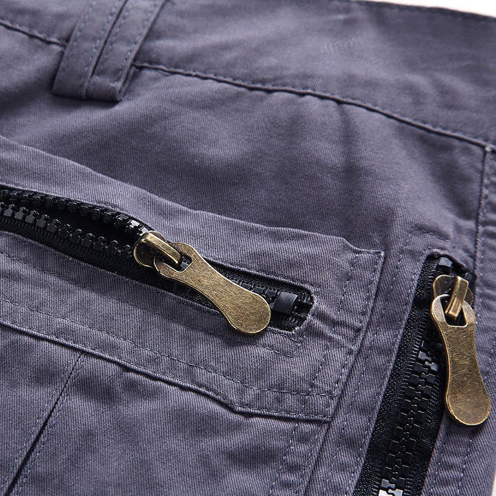 Grey cargo shorts pocket with bronze zip pull and contrast stitching