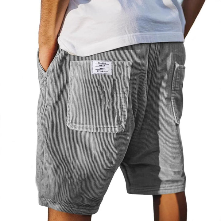 Grey corduroy tailored shorts with rear patch pocket and branded label