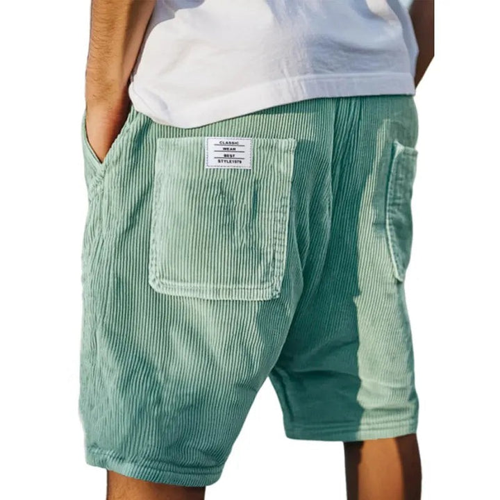 Sage green corduroy tailored shorts with rear pocket and fabric label