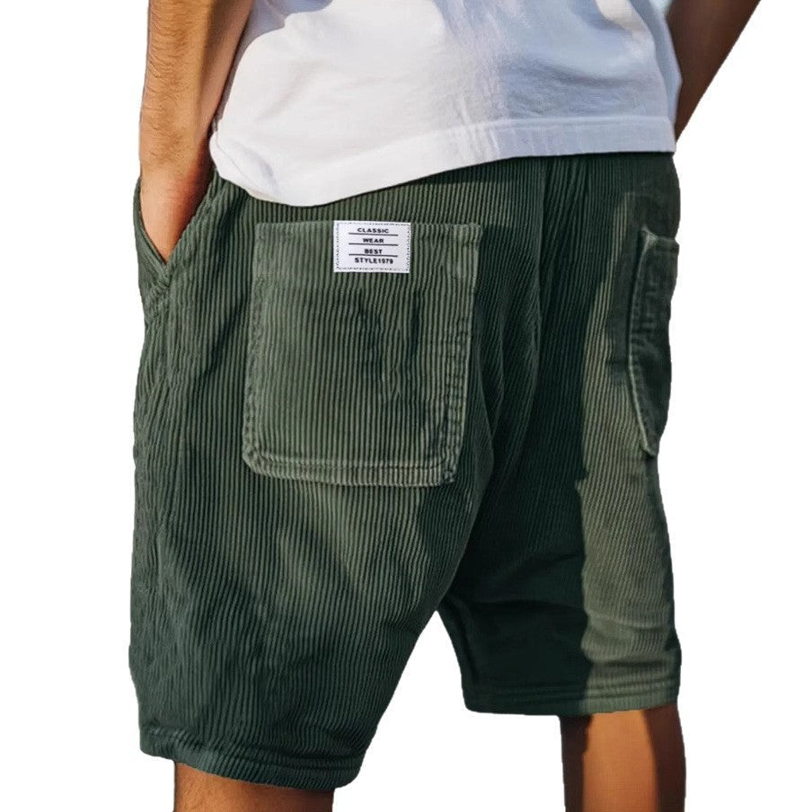 Olive green corduroy tailored shorts with textured finish and rear pocket