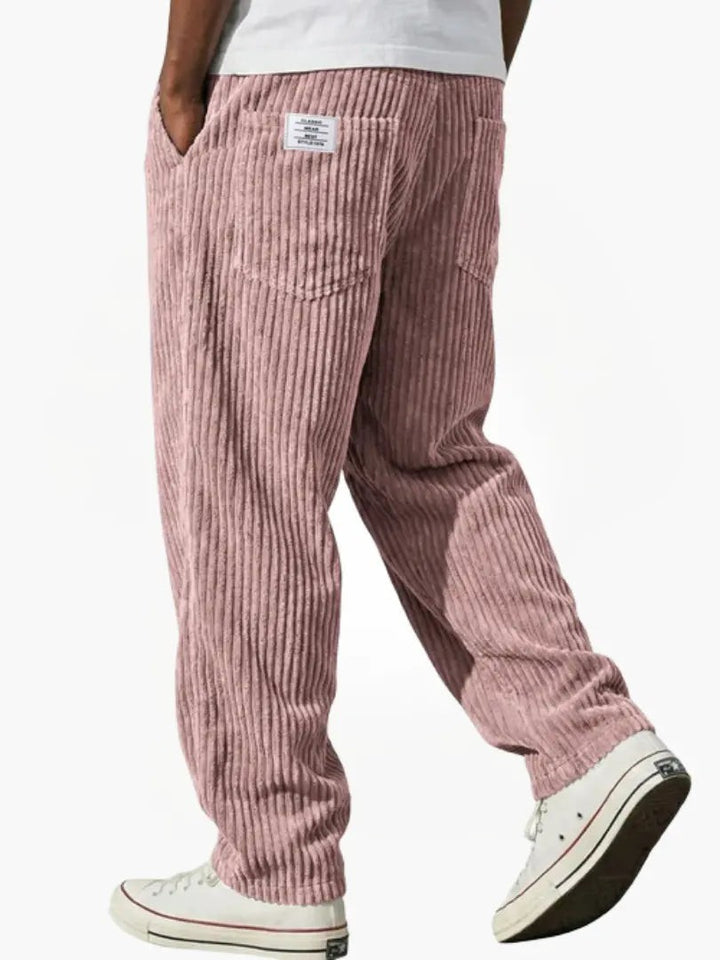 Dusty pink corduroy trousers with wide-leg cut and ribbed texture