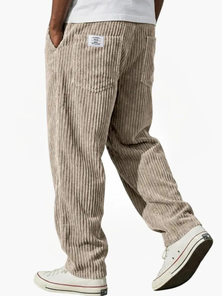 Beige corduroy trousers in a loose, relaxed fit with patch pockets