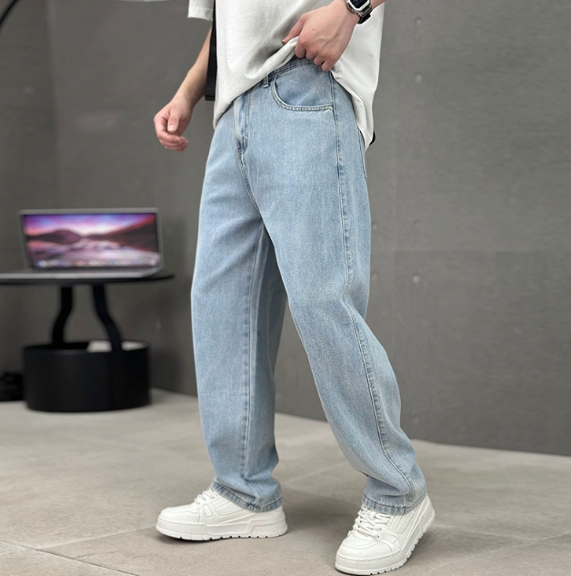 Light blue wash relaxed straight leg jeans worn with white trainers