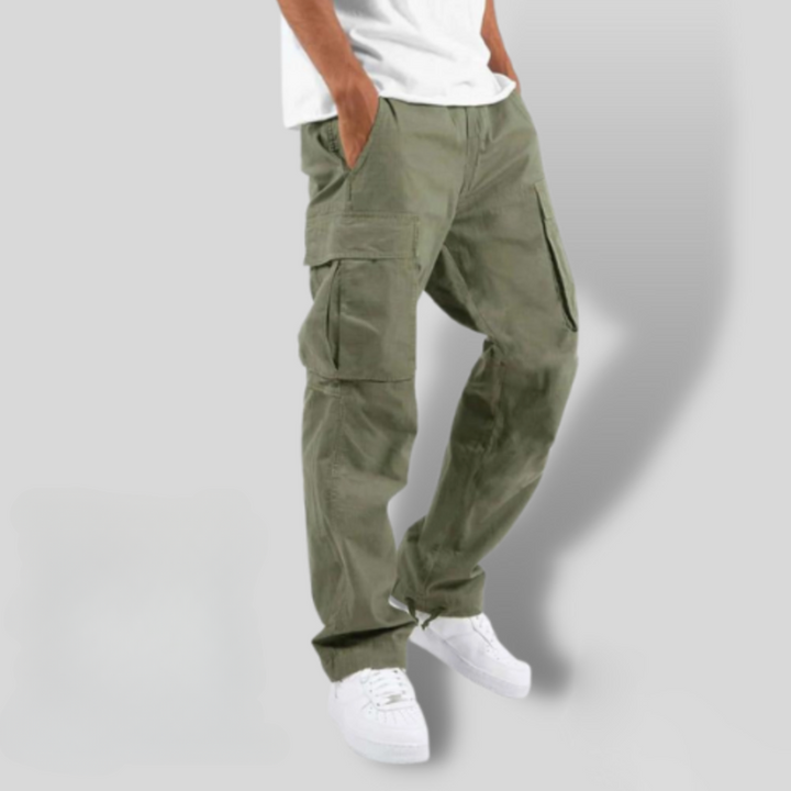 Khaki green cargo trousers with side utility pockets, loose fit, worn with white trainers