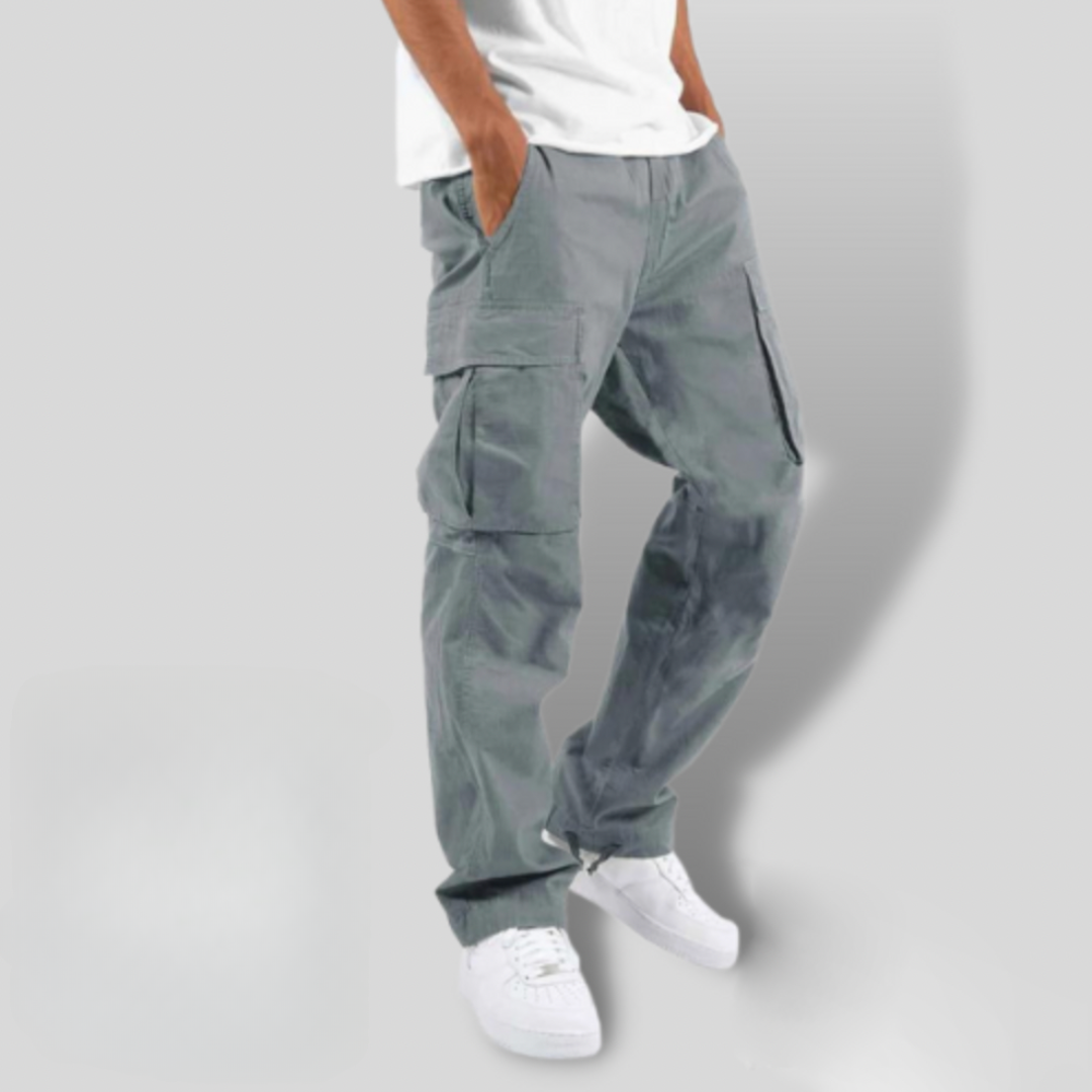 Slate grey cargo trousers showing loose fit and cinched ankle drawstring