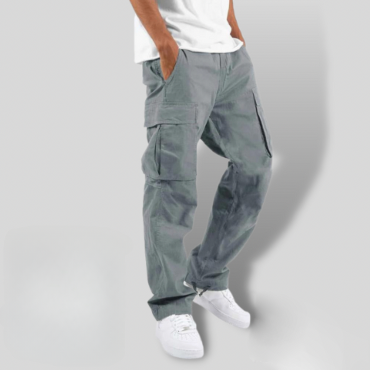 Slate grey cargo trousers showing loose fit and cinched ankle drawstring