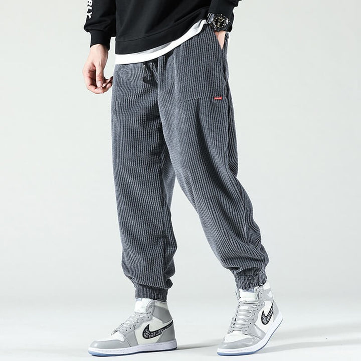 Grey ribbed corduroy tapered trousers with elasticated ankle cuffs
