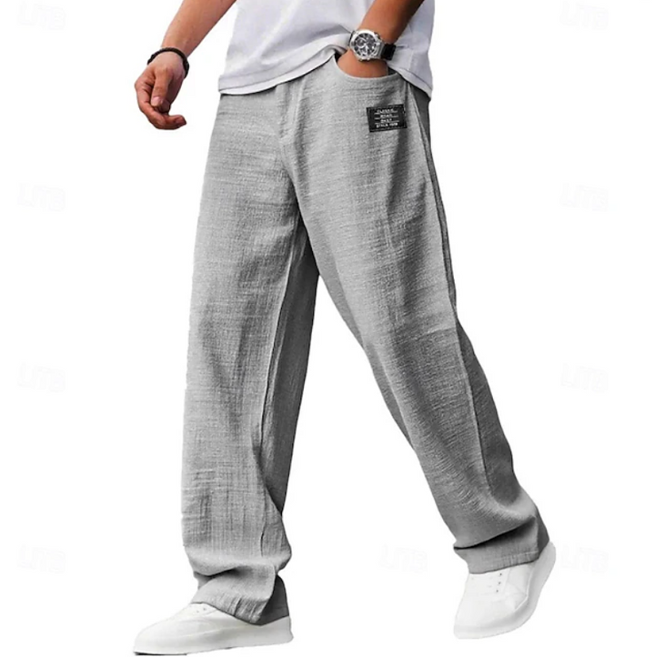 Grey linen-blend relaxed trousers featuring an elasticated waist and patch pocket