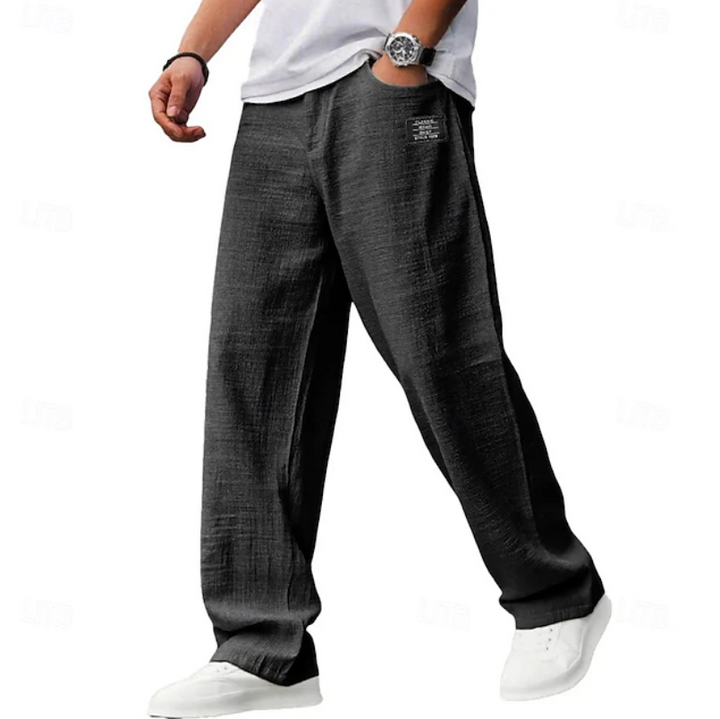 Charcoal grey linen-blend loose trousers featuring a subtle woven texture