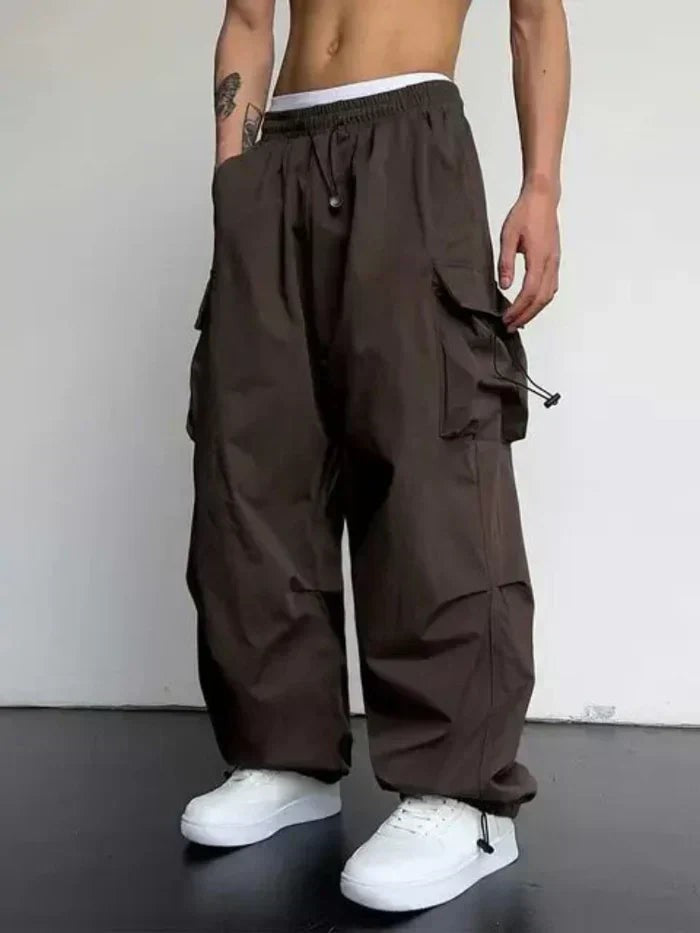 Brown wide-leg cargo trousers with adjustable toggle waist and side pockets