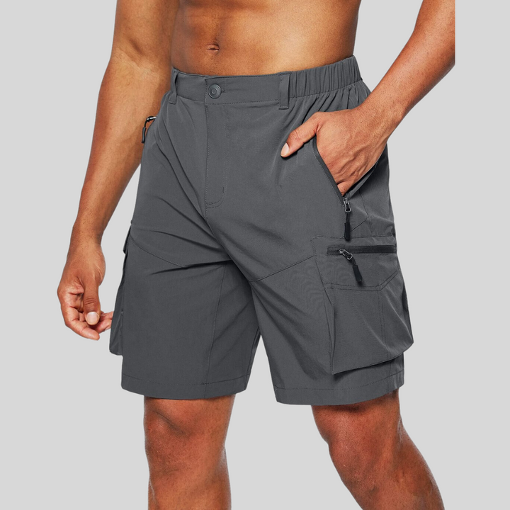 Charcoal grey cargo shorts with zip pockets and elasticated waistband on model