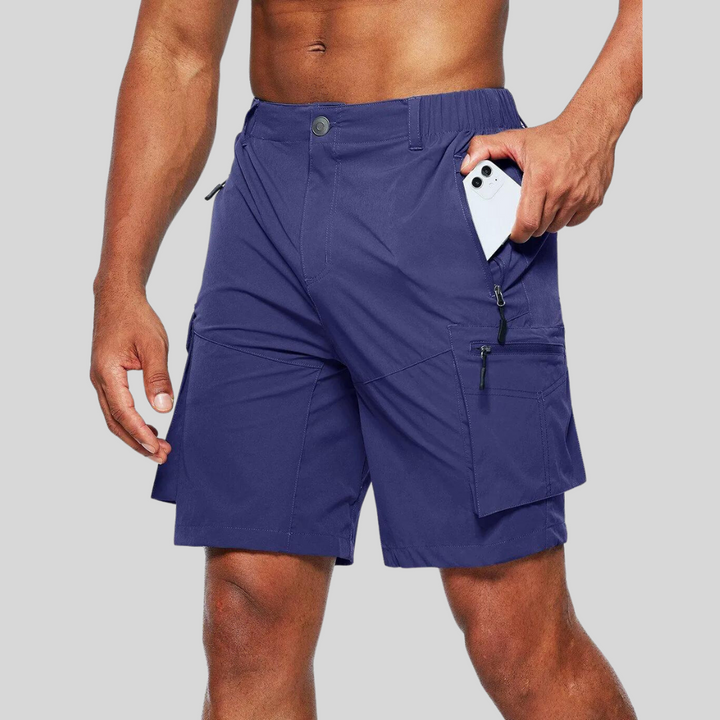 Navy blue cargo shorts with zip pocket holding a smartphone