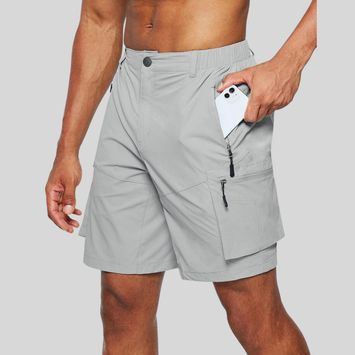 Light grey cargo shorts with zip pocket storing a mobile phone