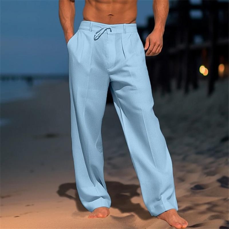 Pale blue wide-leg trousers with drawstring waist, worn barefoot on the beach