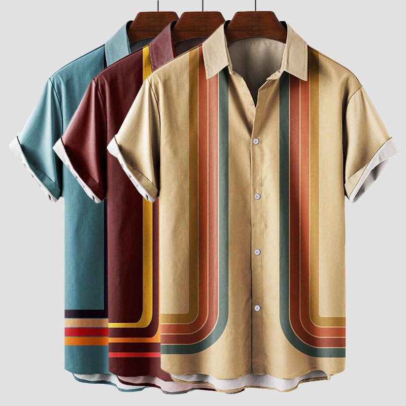 Three retro striped shirts on hangers in teal, burgundy and beige colourways
