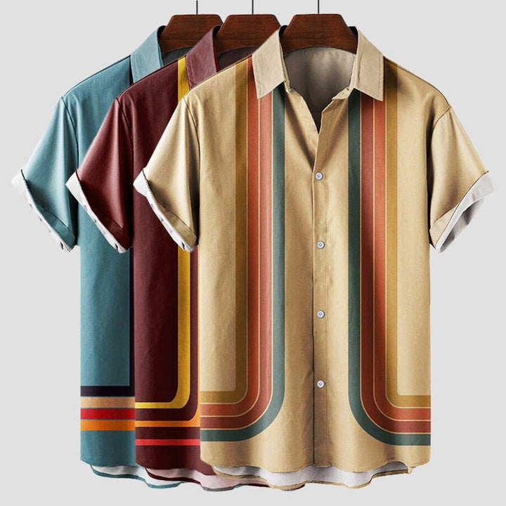 Three retro striped shirts on hangers in teal, burgundy and beige colourways