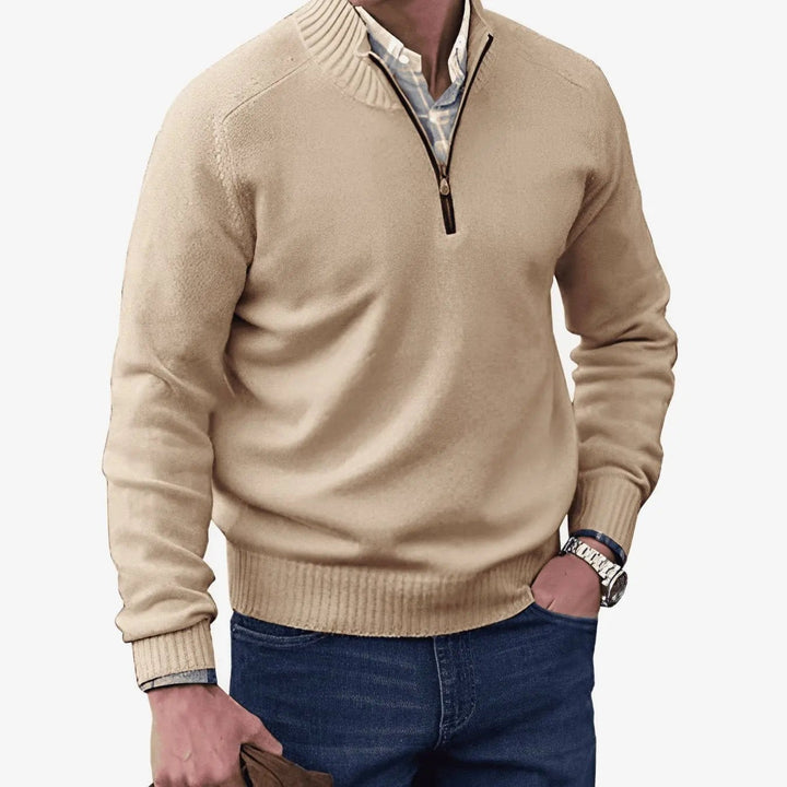 Beige quarter-zip jumper with ribbed collar worn over checked shirt