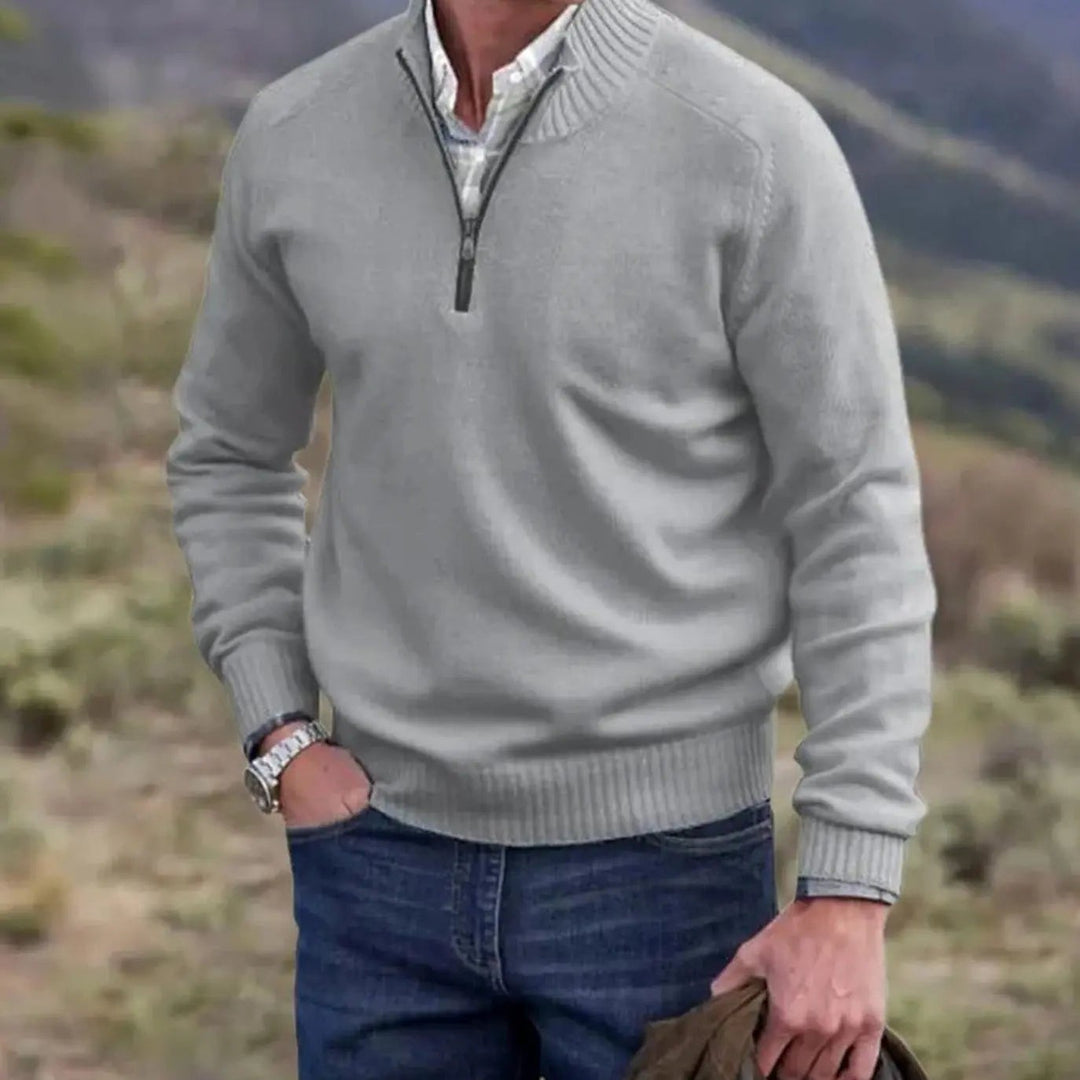 Light grey half-zip knitted jumper styled with denim jeans outdoors