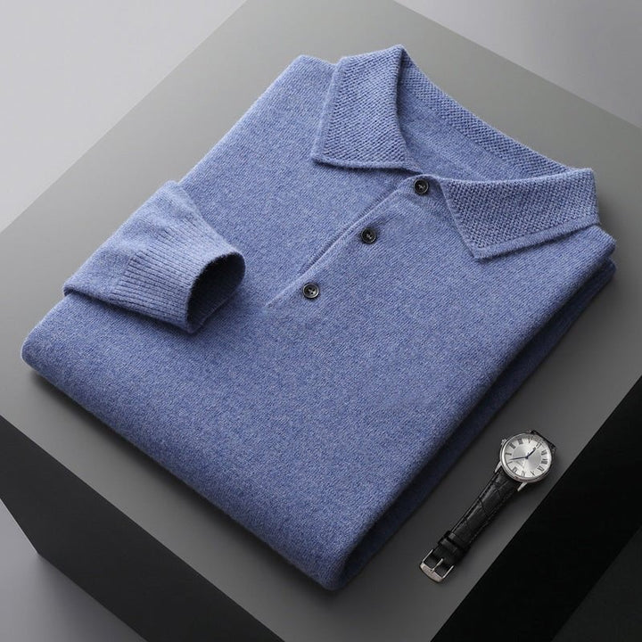 Light blue knitted polo jumper folded neatly beside a wristwatch