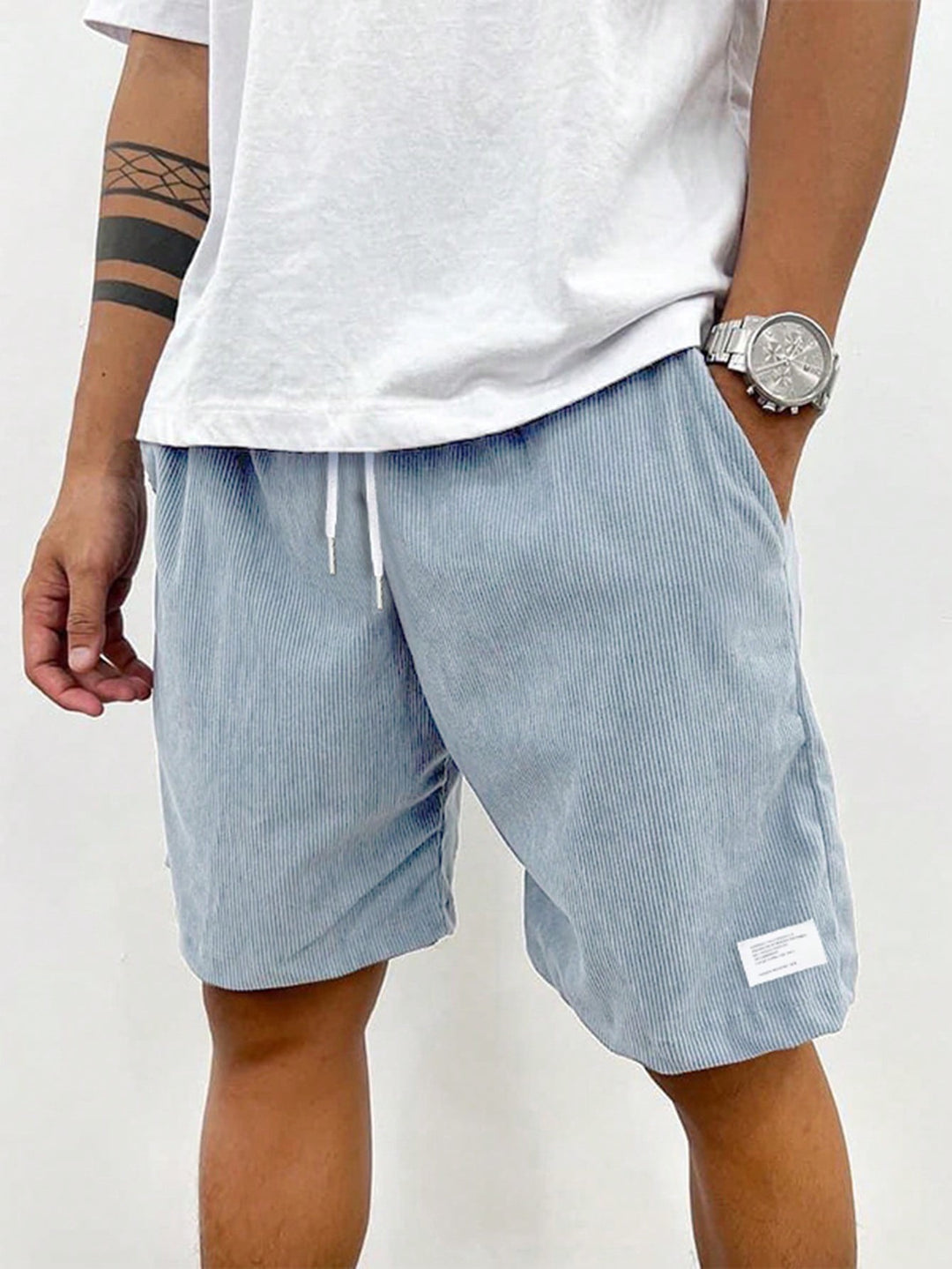 Light grey corduroy casual shorts with white drawstring, close-up front view