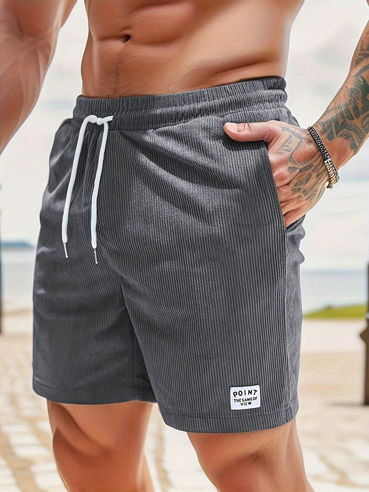 Charcoal grey ribbed corduroy shorts with contrast patch pocket label