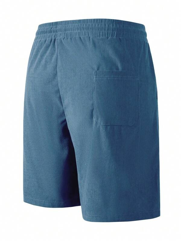 Back view of teal ribbed corduroy shorts showing patch pocket and elastic waistband