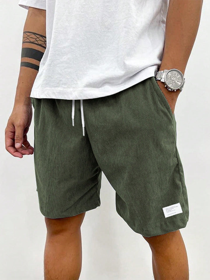 Olive green corduroy shorts featuring drawstring waistband and ribbed texture