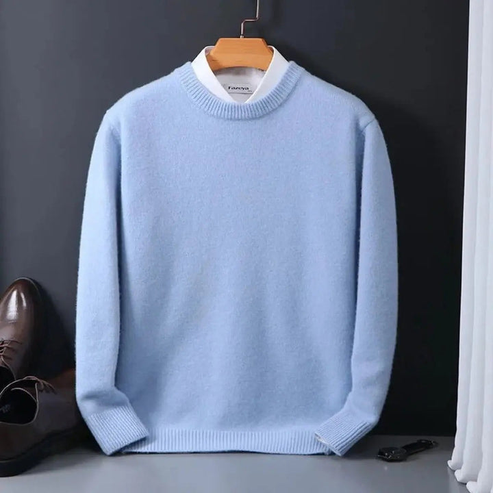 Pale blue ribbed crew neck jumper worn over a white collared shirt on hanger
