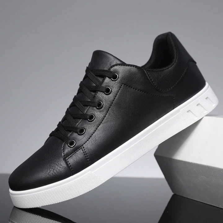 Black leather lace-up trainers featuring a crisp white sole unit