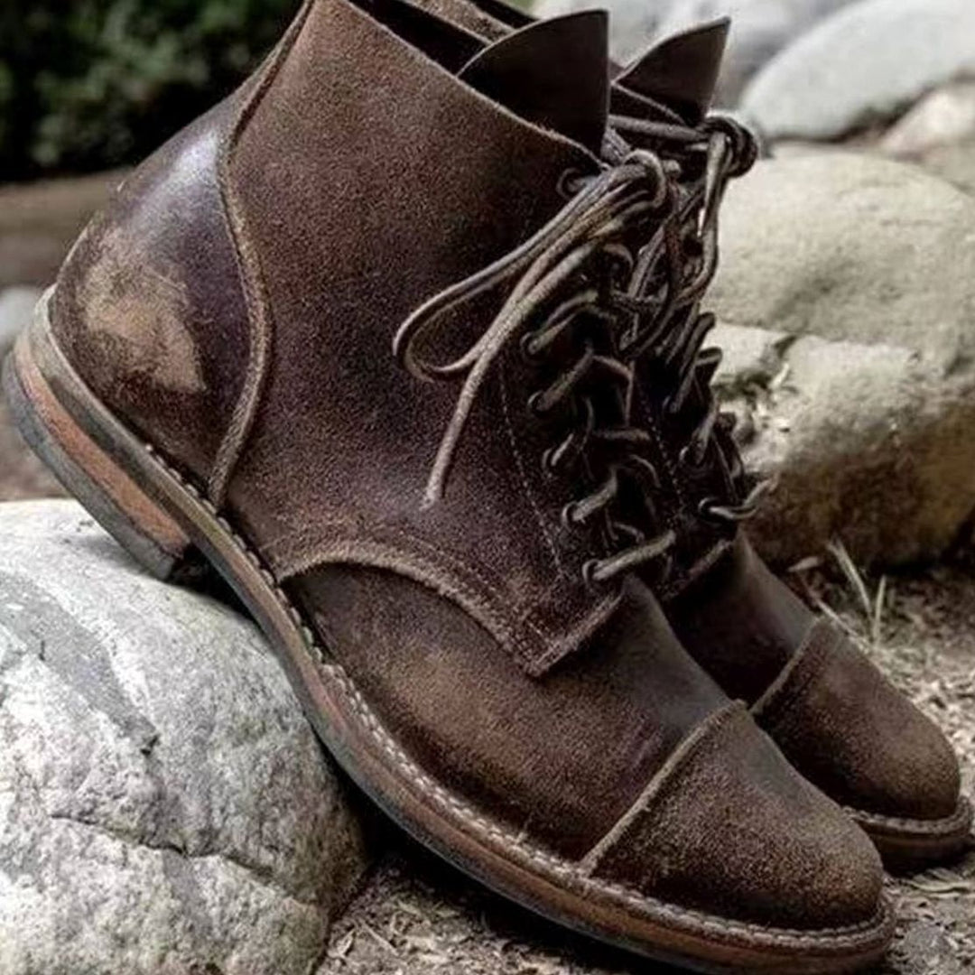 Distressed brown leather lace-up boots with rugged worn-in finish