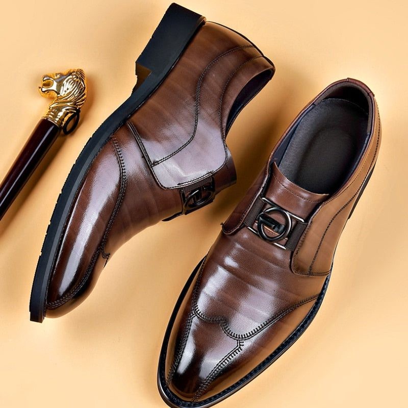 Pair of brown leather monk strap shoes beside gold-topped cane