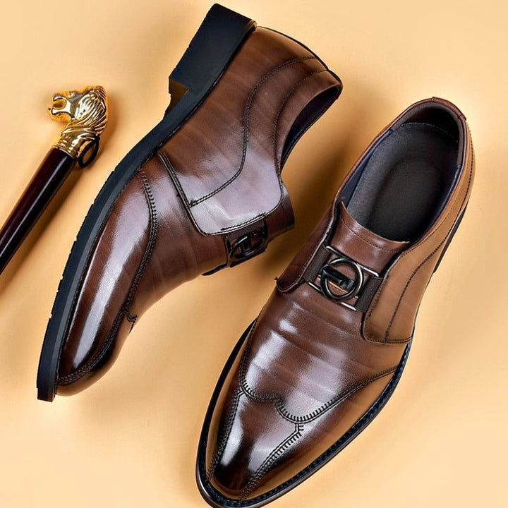 Pair of brown leather monk strap shoes beside gold-topped cane