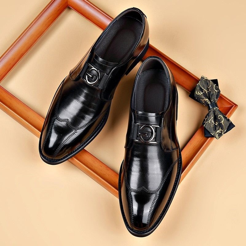 Black pointed-toe monk strap shoes styled with patterned bow tie